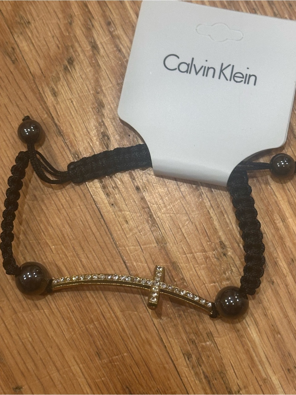 Calvin Klein Black Braided Bracelet with Gold Crystal Cross